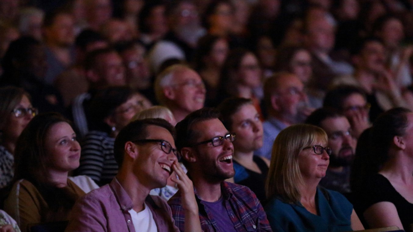 People laughing at a doc fest screening